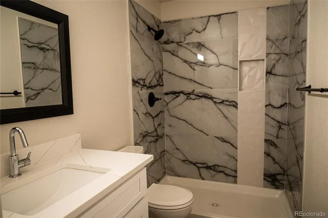 a bathroom with a sink toilet and shower