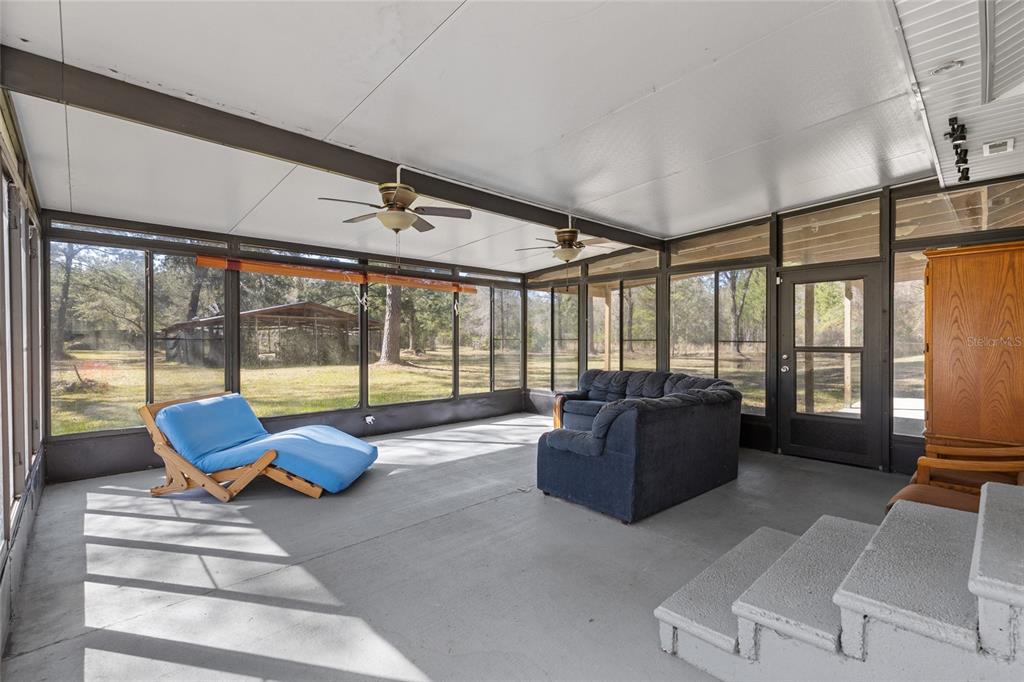 1317 Northeast Drew Road Lake City, FL 32055 - Photo 13 of 32 a living room with furniture and large windows