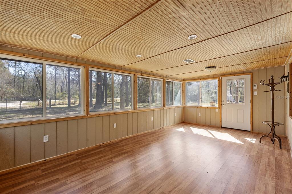 1317 Northeast Drew Road Lake City, FL 32055 - Photo 19 of 32 a view of an empty room with wooden floor and a window