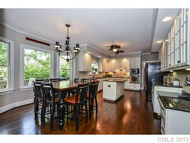 700 Beacon Knoll Lane Fort Mill, SC 29708 - Photo 7 of 16 a kitchen with stainless steel appliances granite countertop a dining table chairs and wooden floor