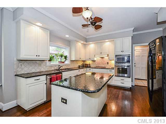700 Beacon Knoll Lane Fort Mill, SC 29708 - Photo 8 of 16 a kitchen with kitchen island white cabinets and stainless steel appliances