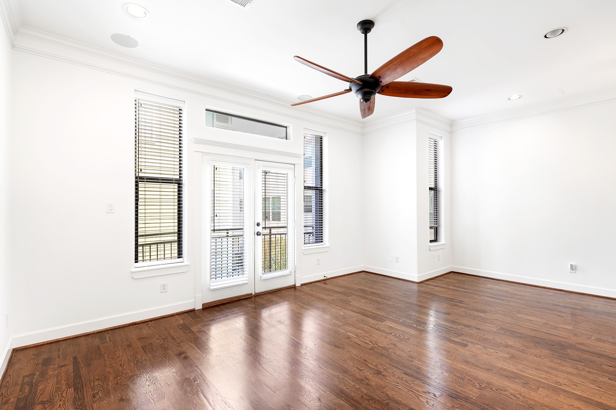 612 West 27th Street Houston, TX 77008 - Photo 9 of 33 an empty room with wooden floor fan and windows