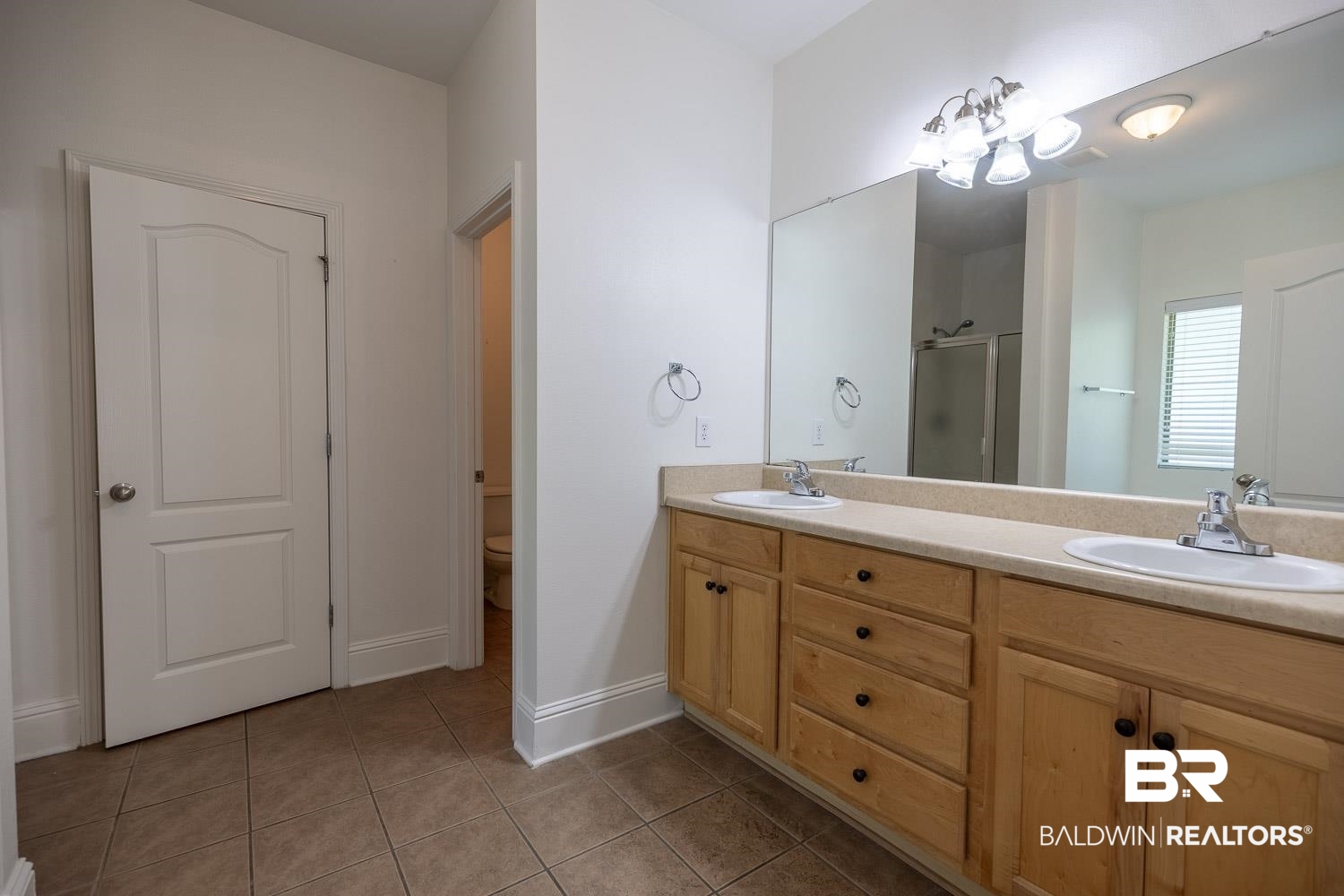 101 Normandy Street Fairhope, AL 36532 - Photo 11 of 18 Full bath featuring a shower stall, double vanity, and light tile patterned floors