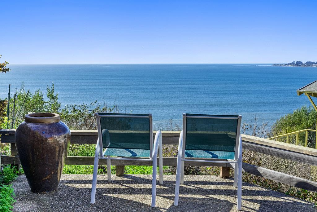 a view of a two chairs and table in the balcony