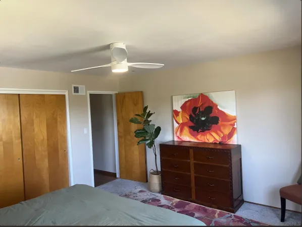 a bedroom with a bed and a dresser