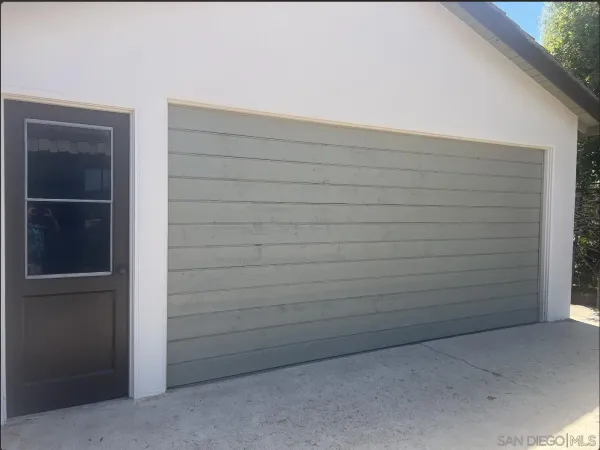 a picture of a room with wooden floor and windows