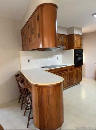 a kitchen with a stove microwave and cabinets