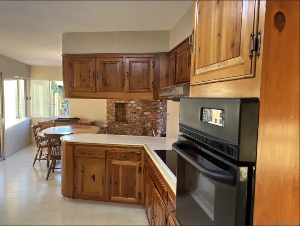 a kitchen with granite countertop cabinets stainless steel appliances and a counter space