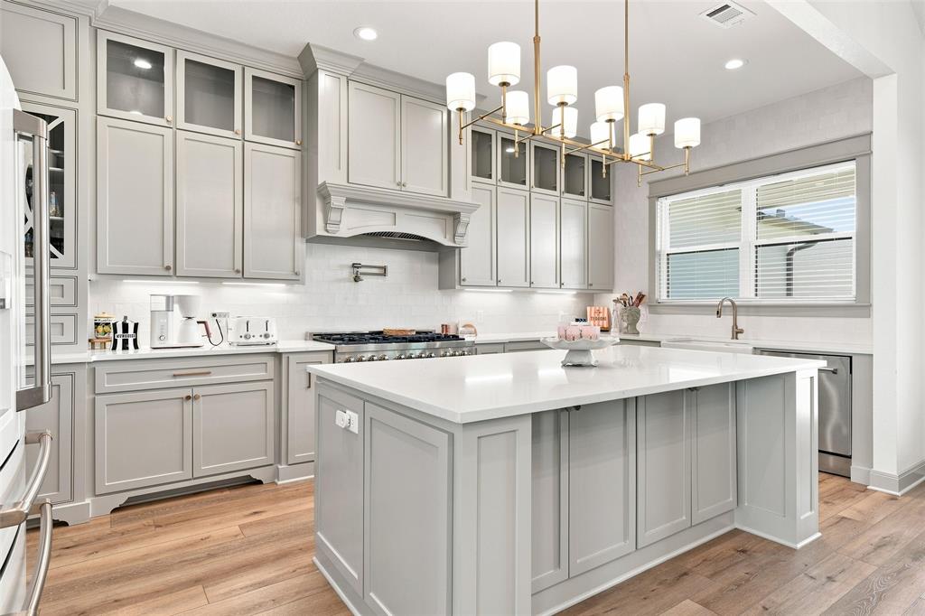 803 Willow Moon Ranch Road Crawford, TX 76638 - Photo 11 of 37 Gourmet kitchen with light gray cabinetry, a central island, and wood-finish flooring