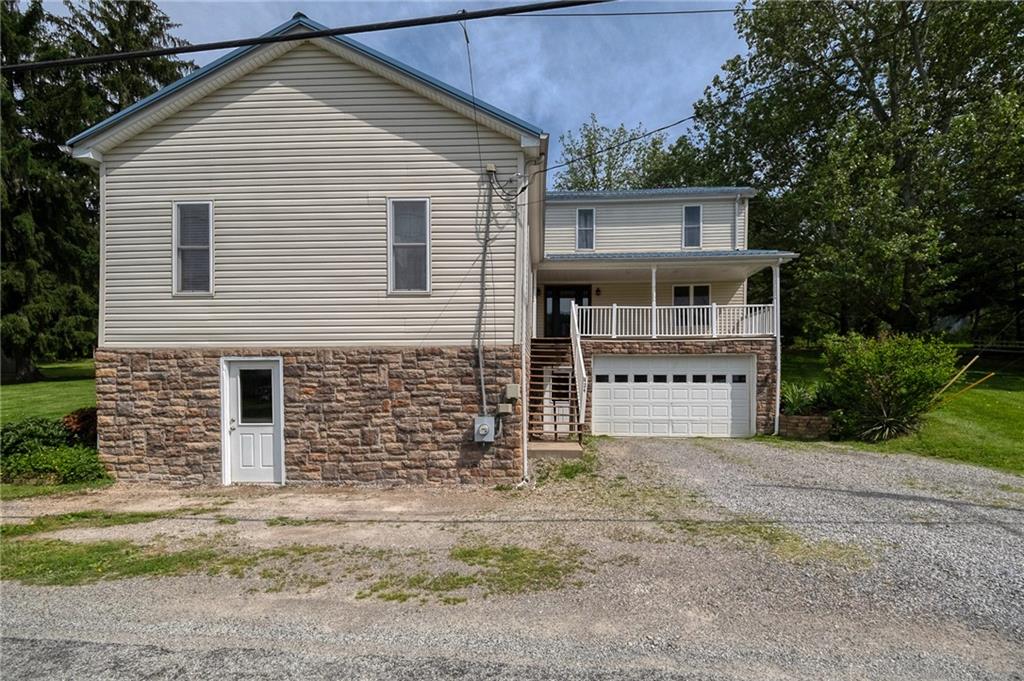 424 Joffre Cherry Valley Road Burgettstown, PA 15021 - Photo 16 of 40 a front view of a house with a yard and garage