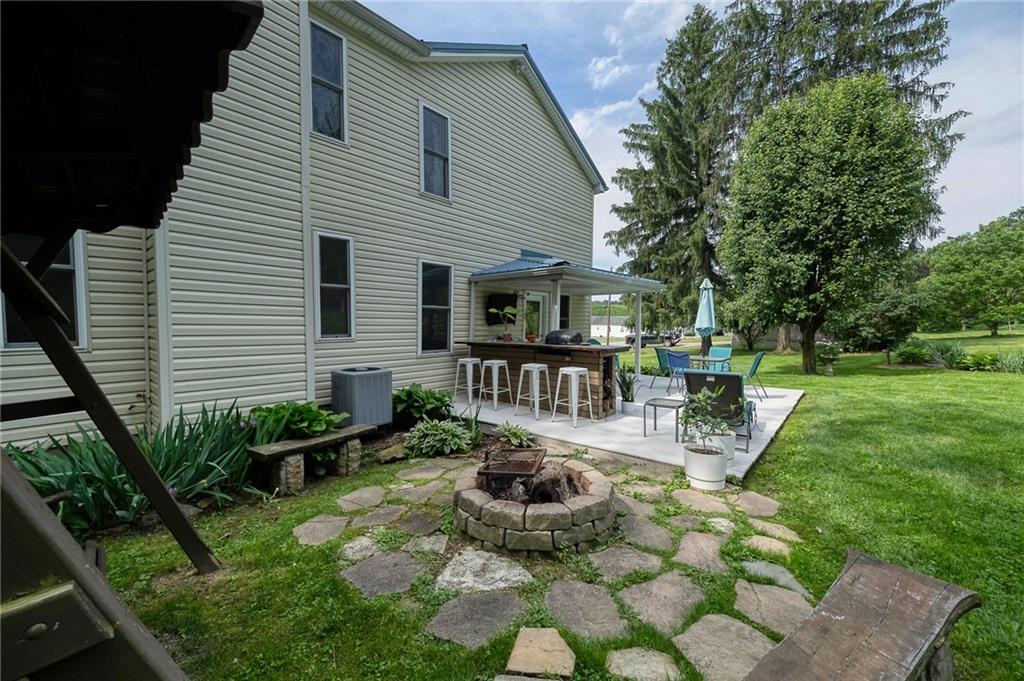 424 Joffre Cherry Valley Road Burgettstown, PA 15021 - Photo 5 of 40 a view of a chair and tables in the backyard