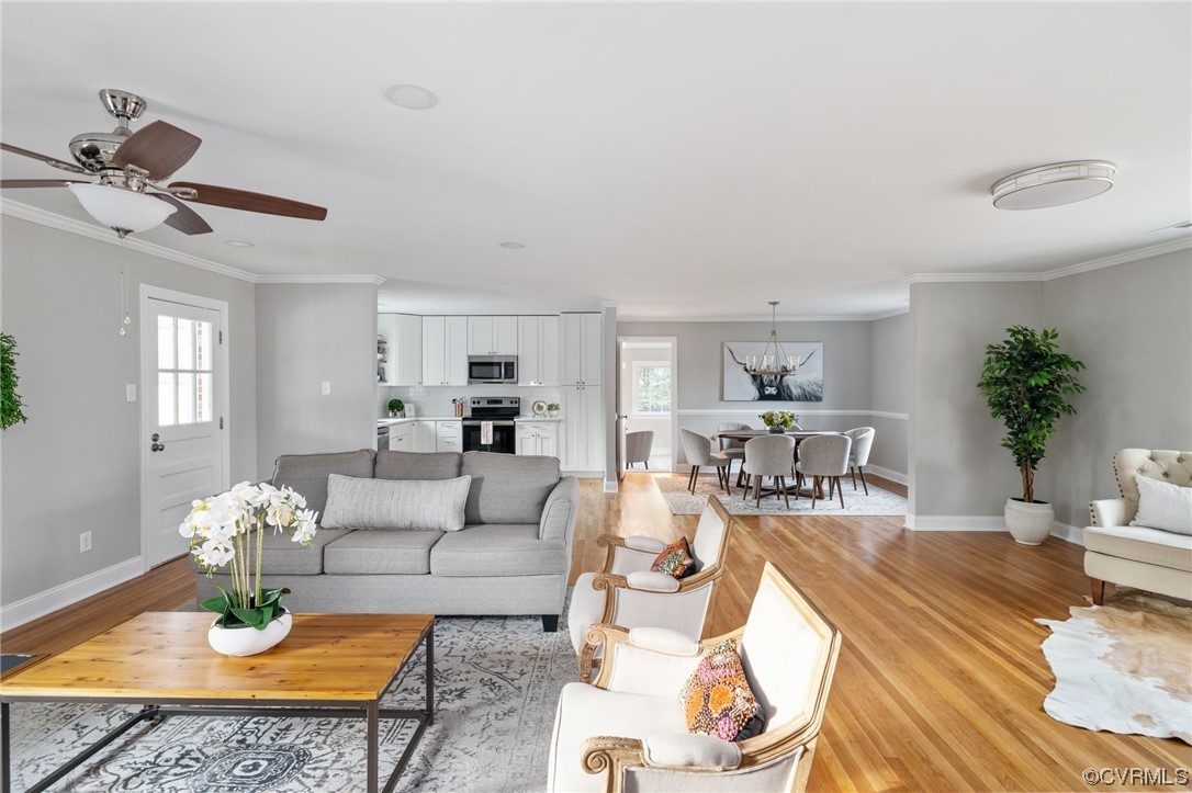 1818 Bloomfield Road Richmond, VA 23225 - Photo 12 of 45 a living room with furniture a rug and a chandelier