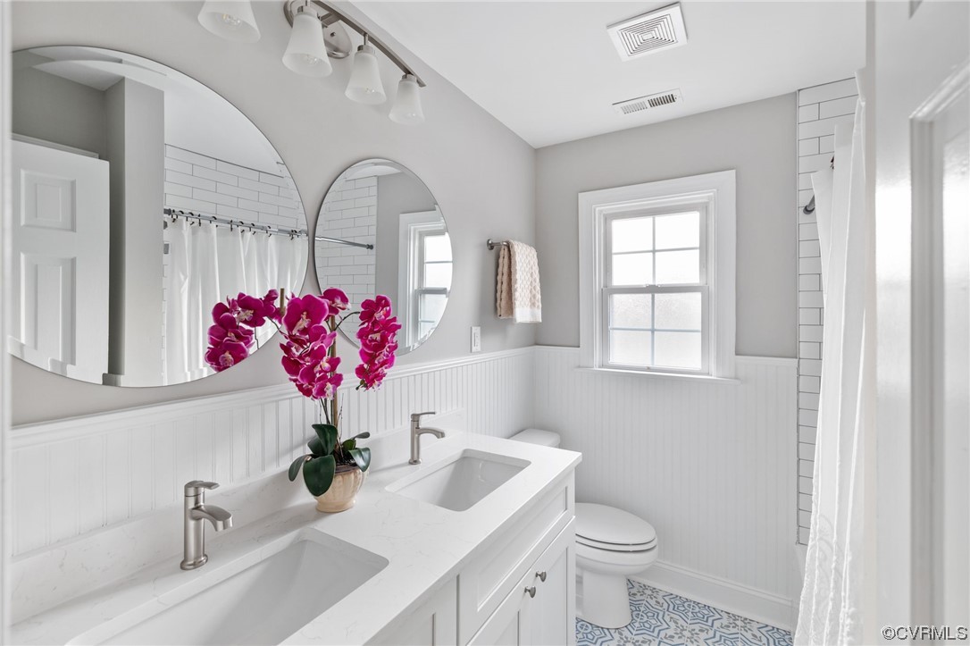 1818 Bloomfield Road Richmond, VA 23225 - Photo 19 of 45 a bathroom with a sink mirror and toilet