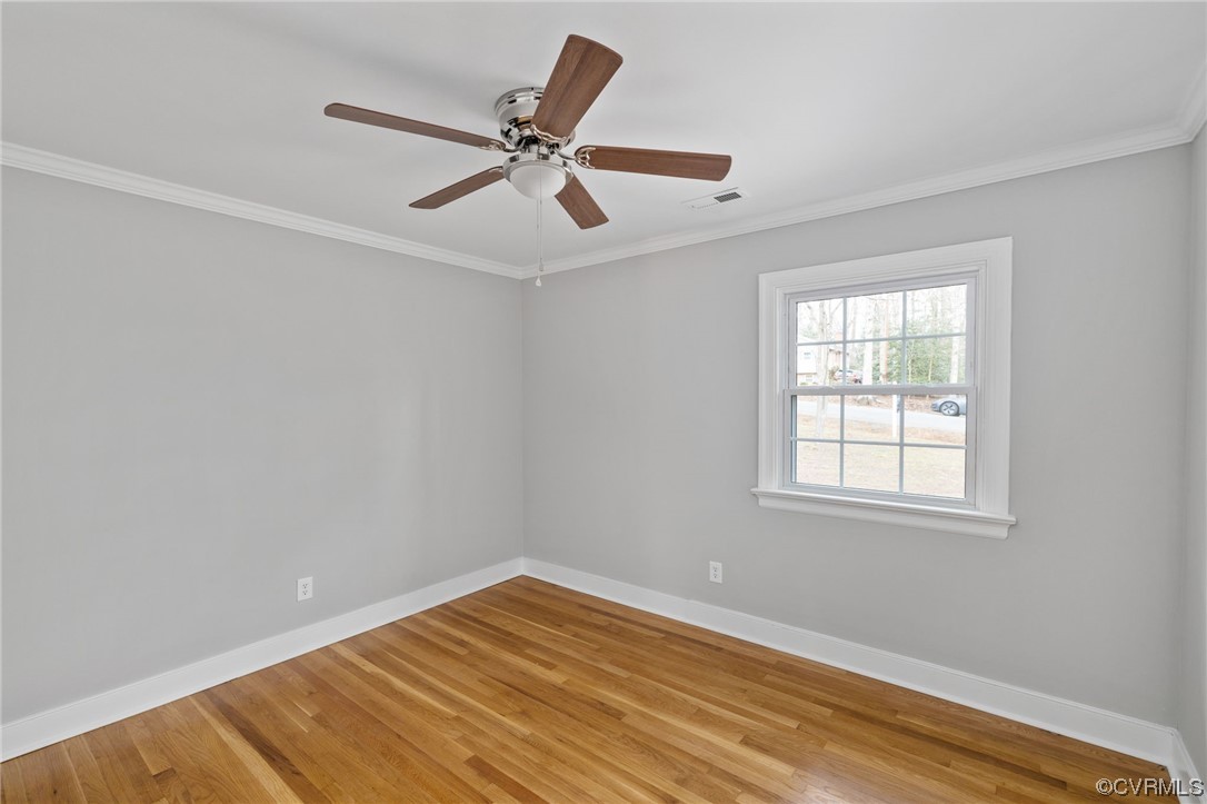 1818 Bloomfield Road Richmond, VA 23225 - Photo 22 of 45 an empty room with wooden floor fan and windows