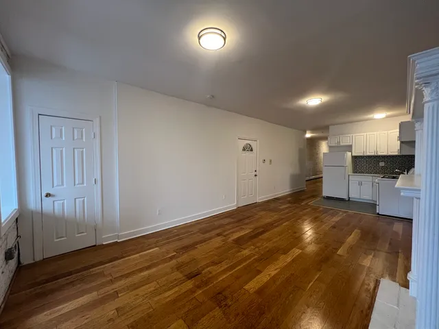 a large kitchen with stainless steel appliances granite countertop a stove and a refrigerator