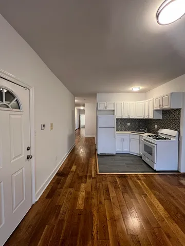 a kitchen with granite countertop a sink cabinets and stainless steel appliances