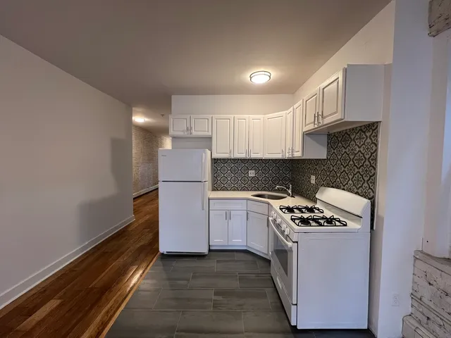 a view of living room with floor to ceiling window and fireplace