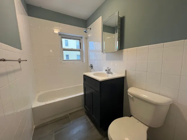 a bathroom with a sink a toilet and bathtub