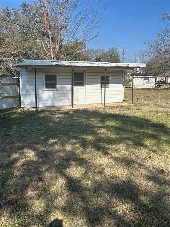 910 South Varella Street Mexia, TX 76667 - Photo 2 of 14 a front view of a house with a yard