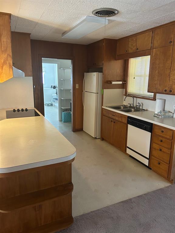 910 South Varella Street Mexia, TX 76667 - Photo 4 of 14 a kitchen with stainless steel appliances a refrigerator sink and cabinets