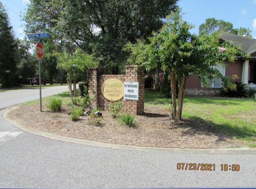Lot 64 Jake South Way Freeport, FL 32439 - Photo 8 of 8 a backyard of a house with plants and outdoor seating