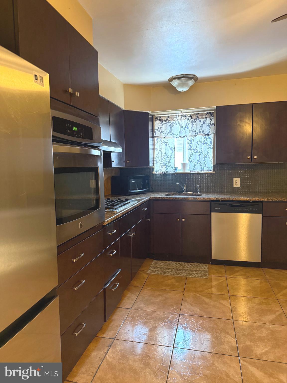 503 Bonsall Avenue Lansdowne, PA 19050 - Photo 11 of 24 a kitchen with stainless steel appliances granite countertop a sink and a stove