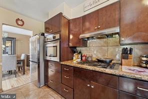 503 Bonsall Avenue Lansdowne, PA 19050 - Photo 12 of 24 a kitchen with stainless steel appliances granite countertop a sink stove and cabinets