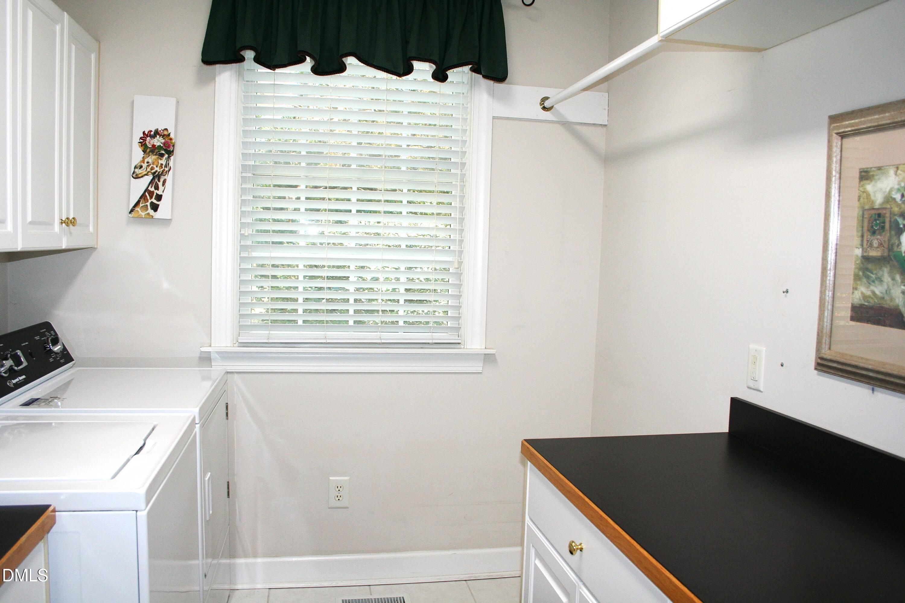 220 Jordan Narron Road Selma, NC 27576 - Photo 30 of 87 a bathroom with a sink and a washing machine