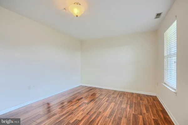 a view of room with wooden floor and fan