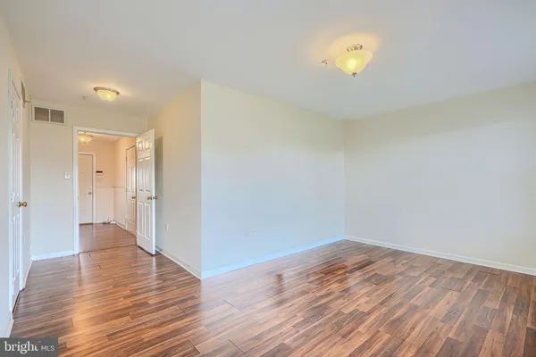 a view of a room with wooden floor and a sink