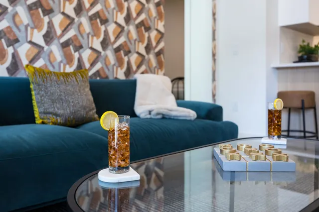 a living room with furniture and a lamp