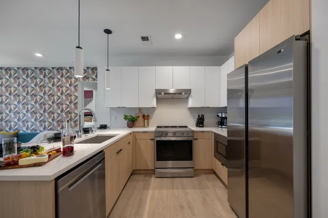 a bedroom with a bed and a lamp on desk