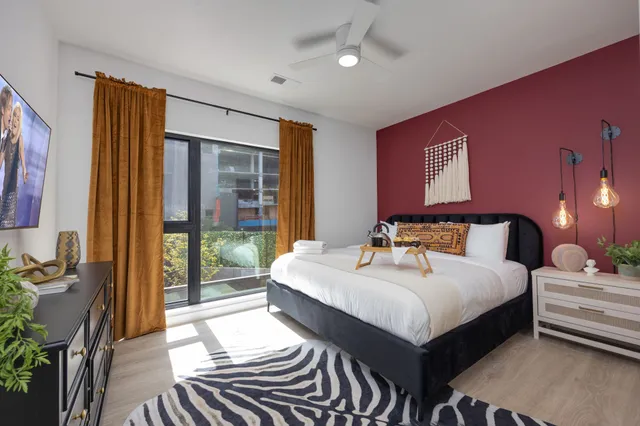 a bedroom with a bed and a window