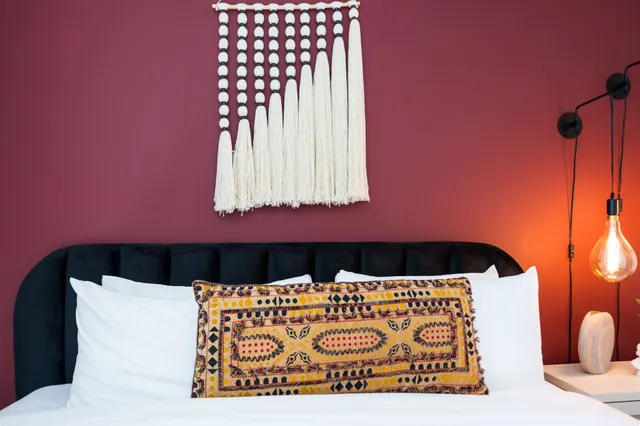 a bedroom with a large bed and a large window