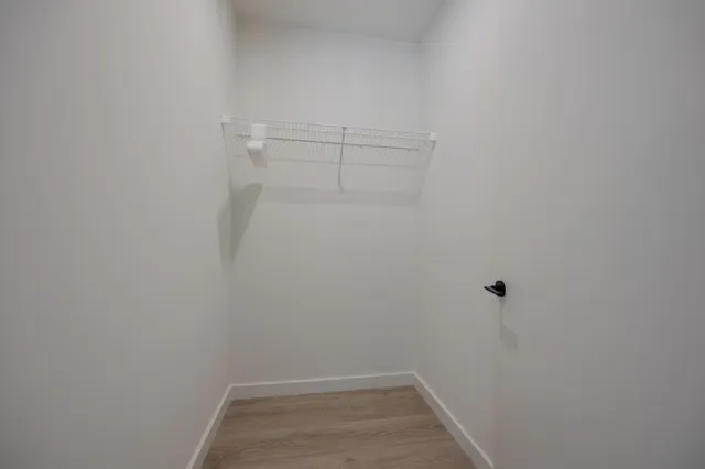 a view of a patio with couches table and chairs under an umbrella with a barbeque