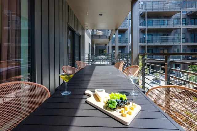 a view of a patio with a table and chairs and potted plants