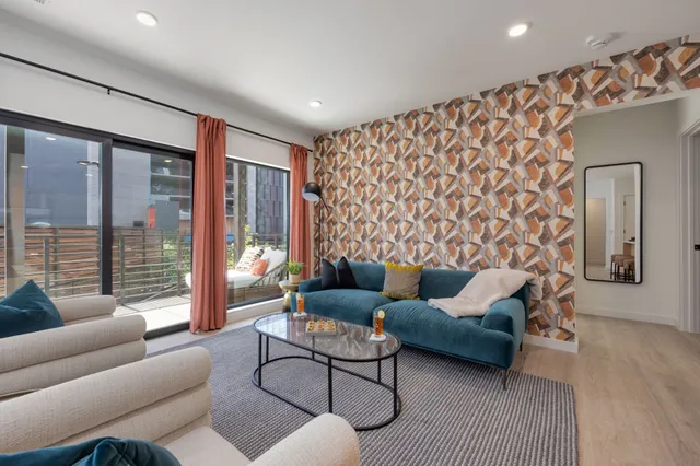 a living room with furniture and a large window