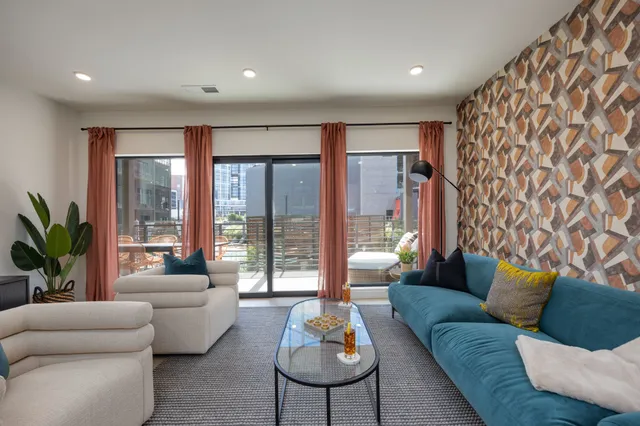 a living room with furniture and a large window