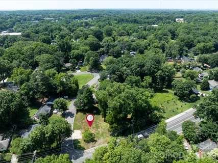 an aerial view of a house with yard