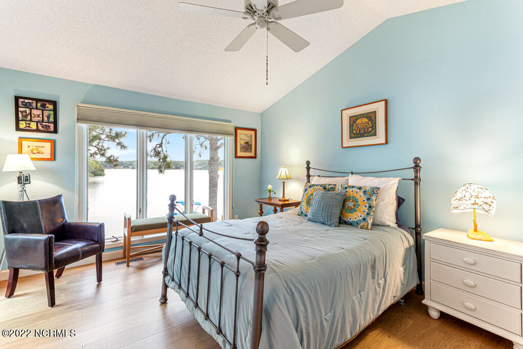 4 Lake Pinehurst Villas Road Pinehurst, NC 28374 - Photo 16 of 56 Vaulted ceilings in primary bedroom with big windows for viewing the lake