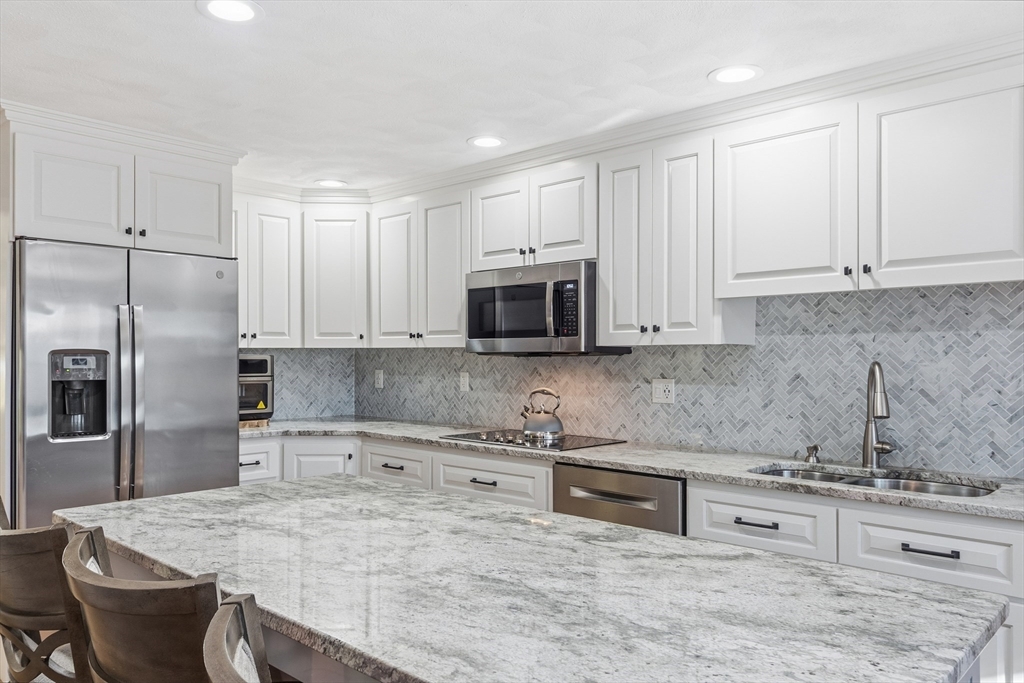 33 Overlook Drive Groton, MA 01450 - Photo 12 of 41 a kitchen with stainless steel appliances granite countertop a sink a stove and a refrigerator