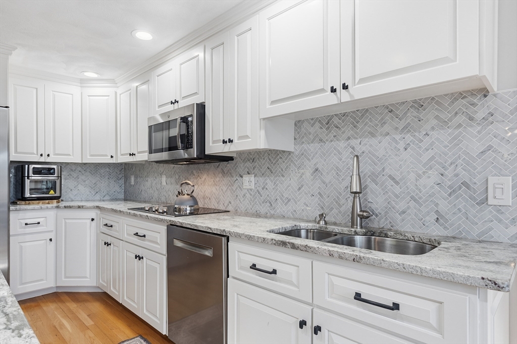 33 Overlook Drive Groton, MA 01450 - Photo 15 of 41 a kitchen with stainless steel appliances granite countertop white cabinets sink and dishwasher
