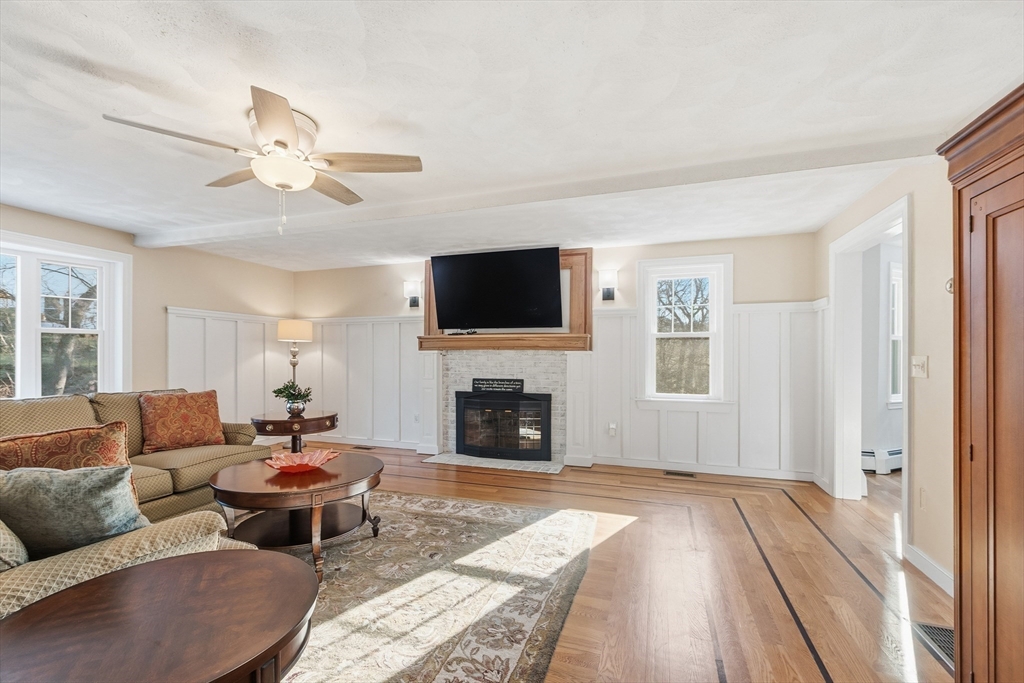 33 Overlook Drive Groton, MA 01450 - Photo 18 of 41 a living room with furniture a fireplace and a flat screen tv
