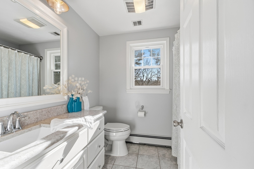 33 Overlook Drive Groton, MA 01450 - Photo 27 of 41 a bathroom with a granite countertop toilet sink and mirror