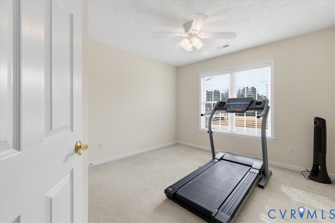 4601 Fall Harvest Court Prince George, VA 23875 - Photo 28 of 49 a room with gym equipment and view of living room