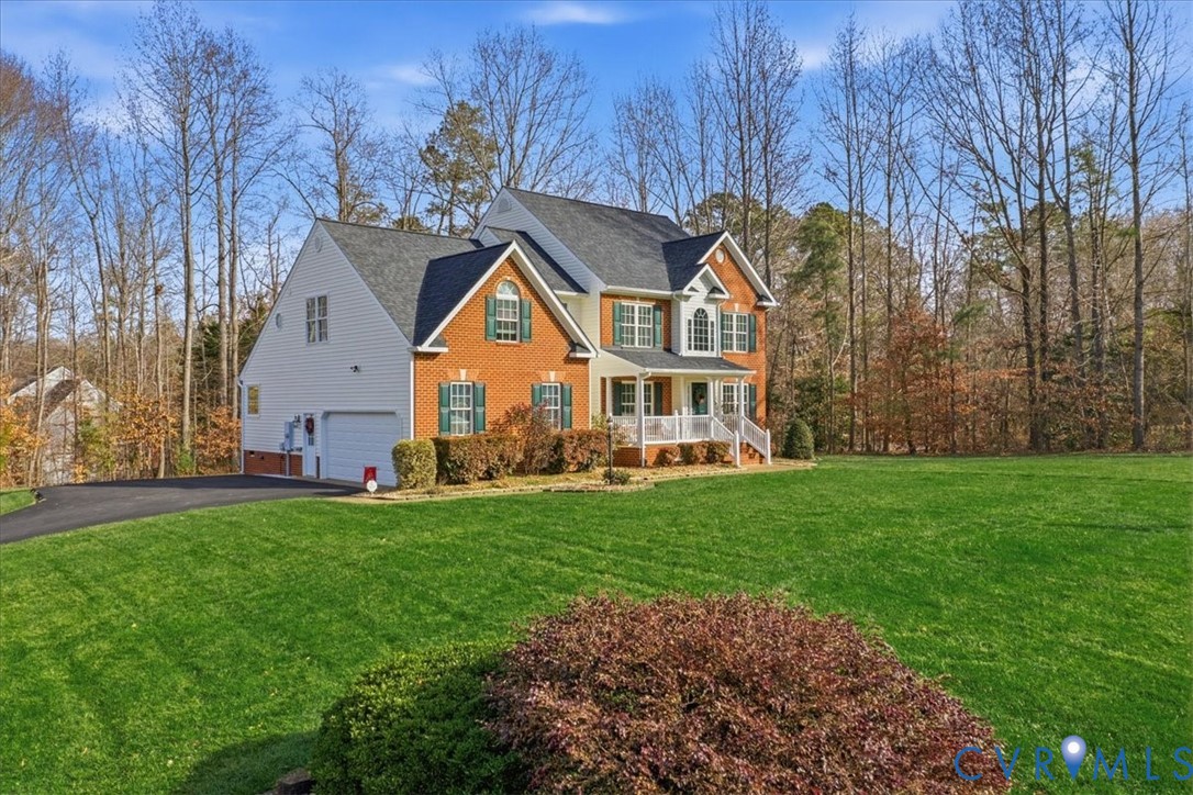 4601 Fall Harvest Court Prince George, VA 23875 - Photo 47 of 49 a front view of a house with a yard and garage