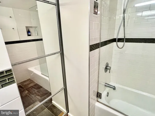 a bathroom with a bathtub and a shower