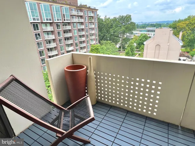 a balcony with table and chairs