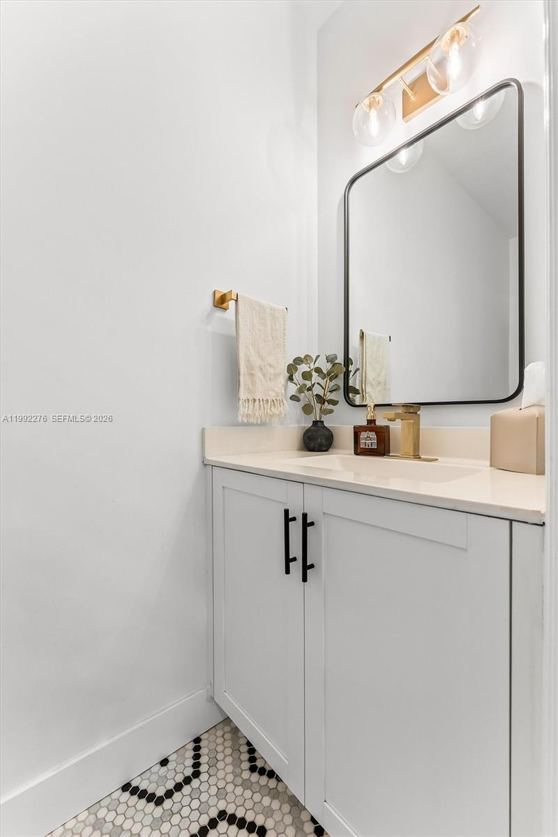 10487 West 34th Court Hialeah, FL 33018 - Photo 16 of 57 a bathroom with a sink and a mirror