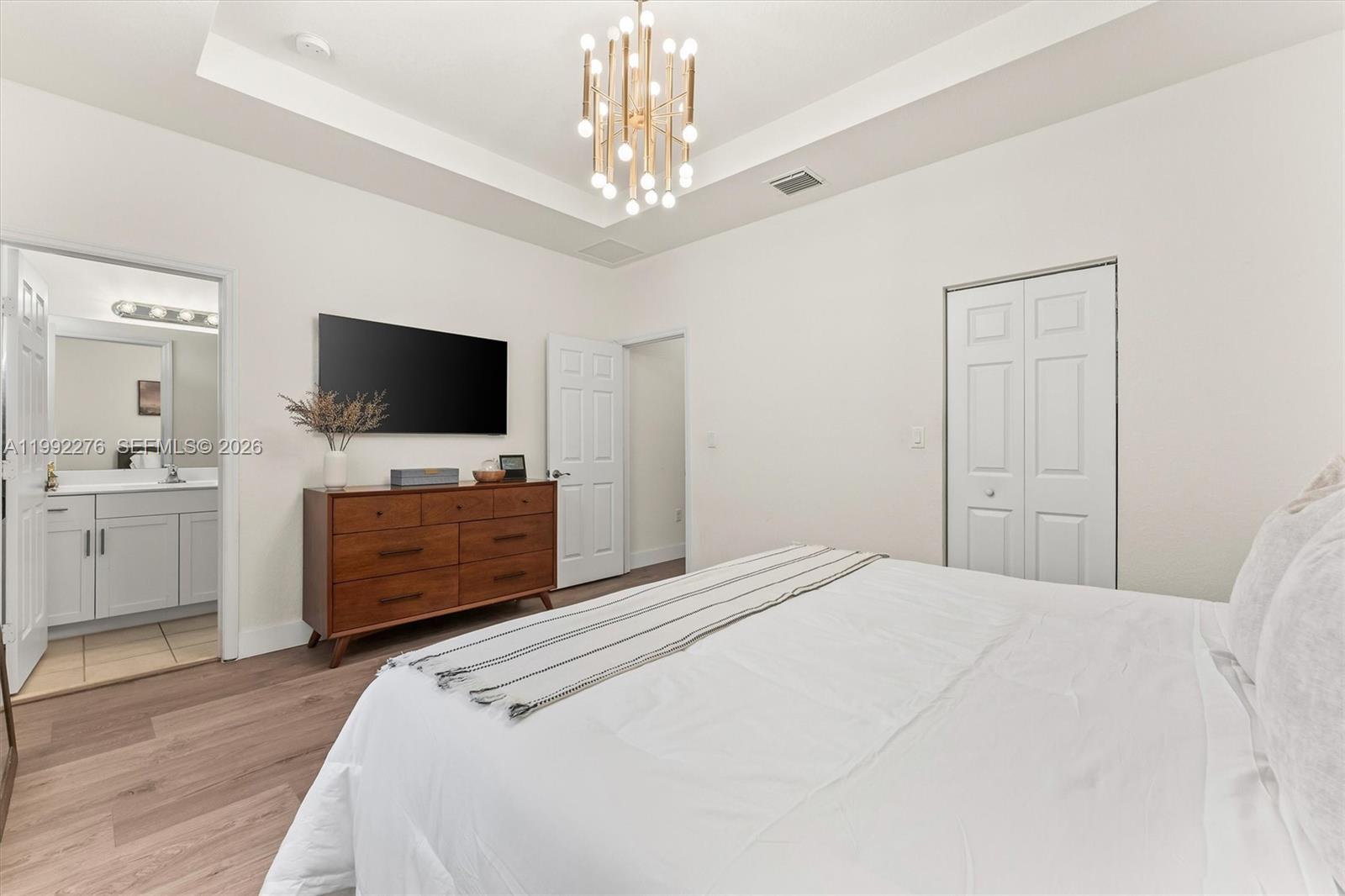 10487 West 34th Court Hialeah, FL 33018 - Photo 23 of 57 a bedroom with a bed and a flat screen tv